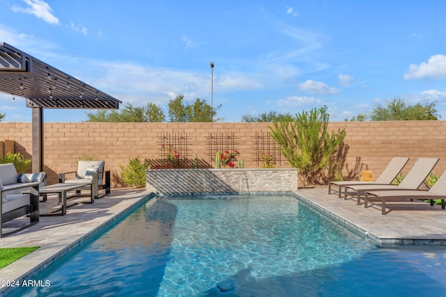 view of swimming pool with pool water feature and a patio