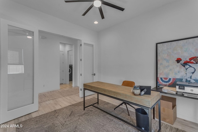 office area featuring ceiling fan, light hardwood / wood-style flooring, and washer / dryer