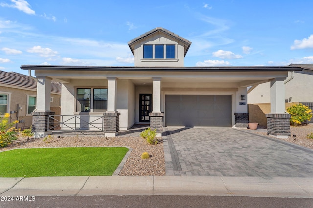 view of front of home with a porch and a garage