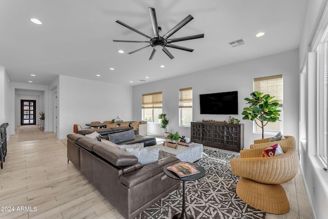 living room with ceiling fan and light hardwood / wood-style floors