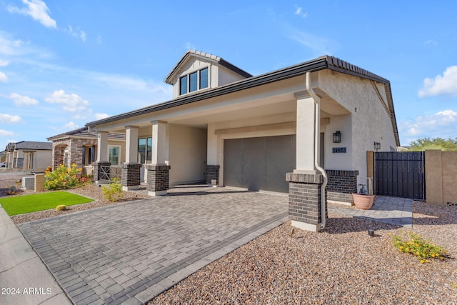 view of front of property featuring a porch and a garage