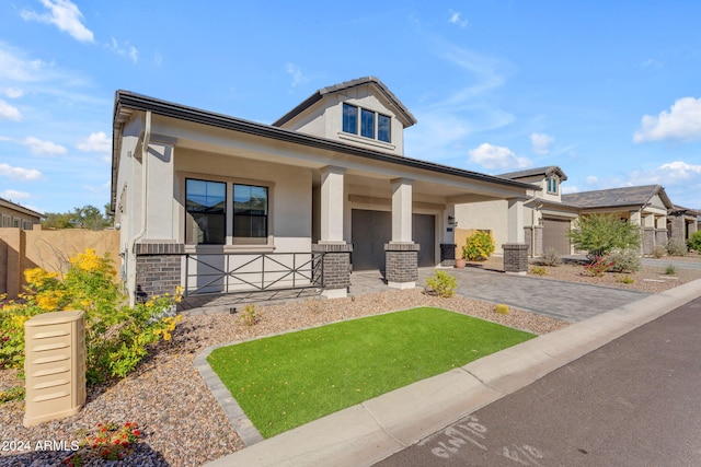 view of front of home with covered porch and a garage