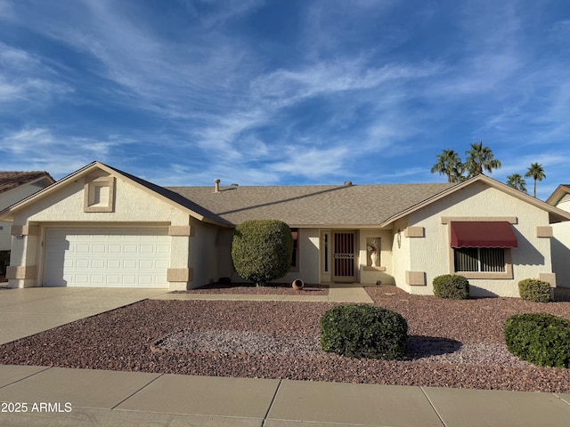 single story home featuring a garage, a shingled roof, concrete driveway, and stucco siding