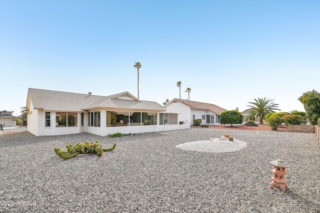 rear view of property with a sunroom