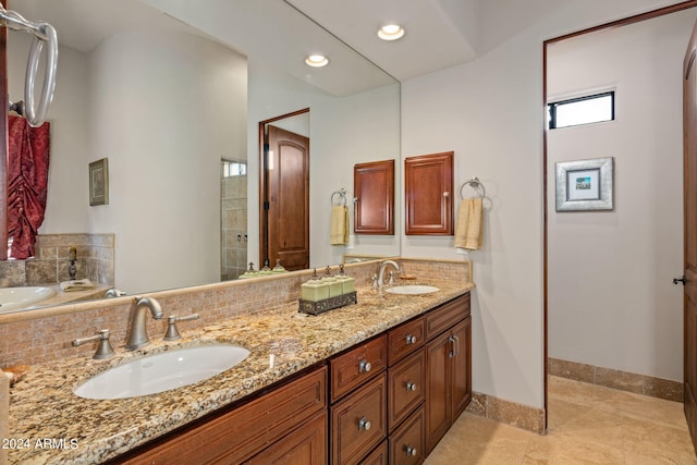 full bath with recessed lighting, a sink, baseboards, and double vanity