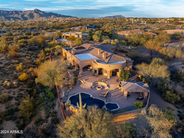 birds eye view of property with a mountain view