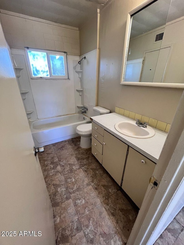 full bathroom with tiled shower / bath combo, toilet, and vanity