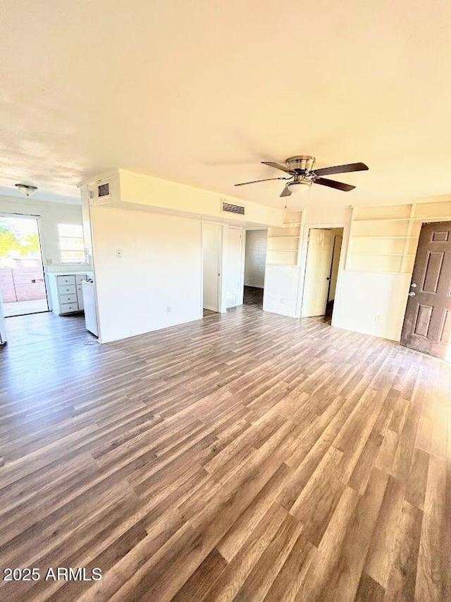 unfurnished living room with ceiling fan and wood-type flooring