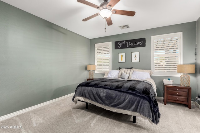 bedroom with ceiling fan, carpet, and multiple windows