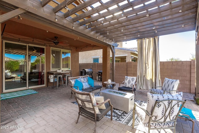 view of patio featuring grilling area, a pergola, an outdoor living space with a fire pit, and ceiling fan