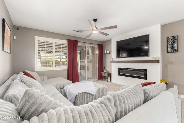 carpeted living room with ceiling fan