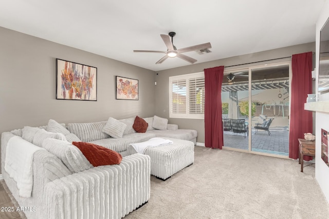 carpeted living room with ceiling fan