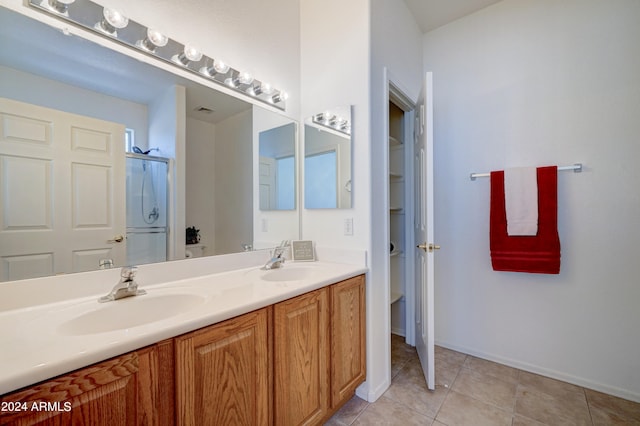 bathroom featuring tile floors and dual vanity