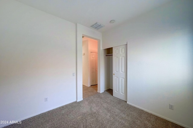 unfurnished bedroom featuring a closet and carpet floors