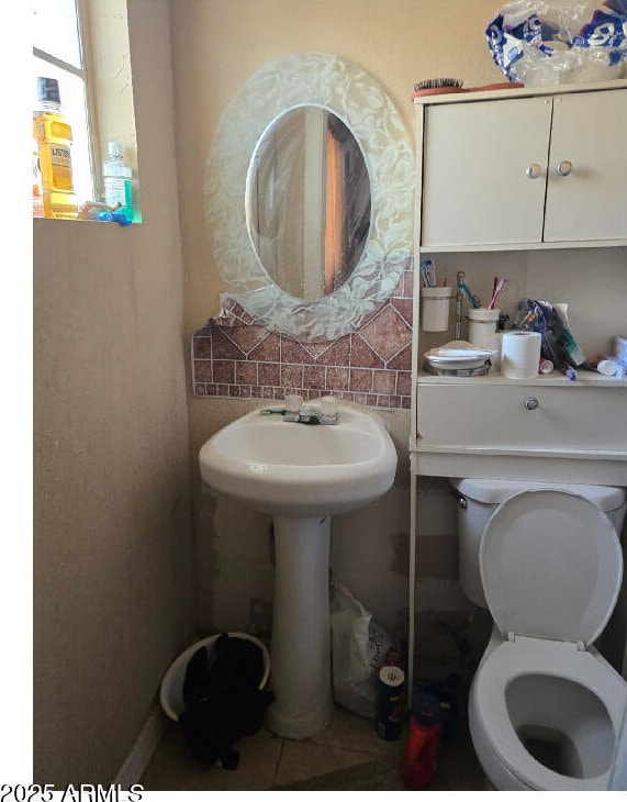 bathroom with tile patterned floors and toilet