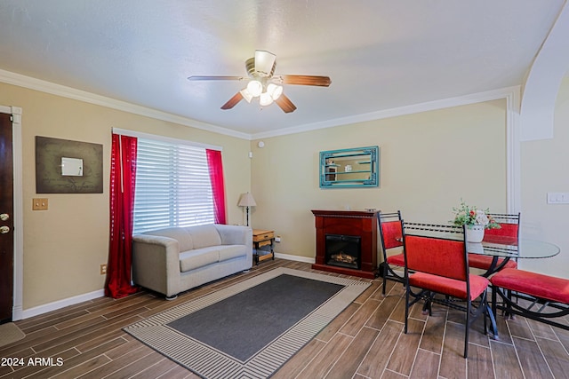 living room with ceiling fan and ornamental molding