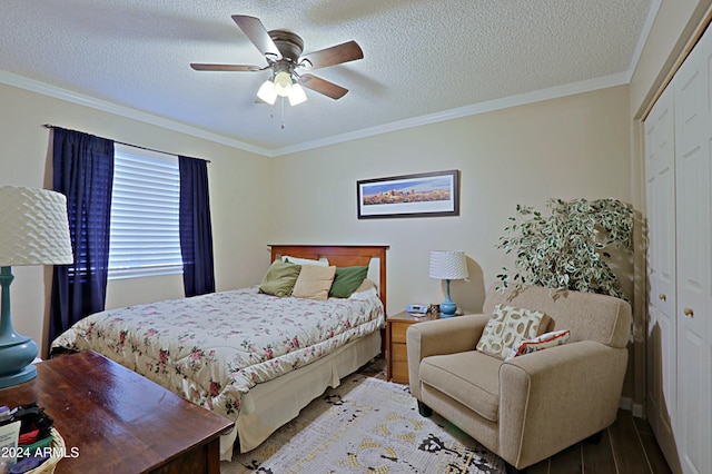 bedroom with hardwood / wood-style floors, ceiling fan, a closet, and crown molding