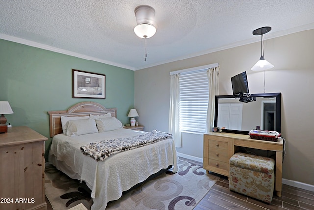 bedroom with a textured ceiling and ornamental molding