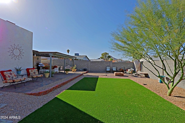 view of yard with a fire pit and a patio area