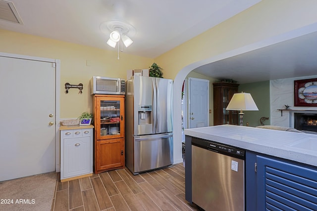 kitchen with a large fireplace and stainless steel appliances