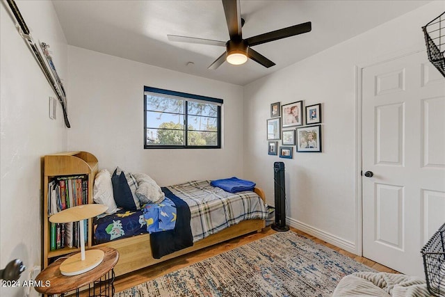 bedroom featuring wood-type flooring and ceiling fan