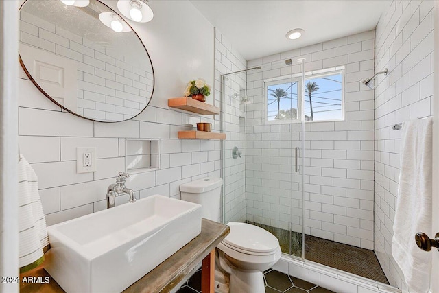 bathroom featuring toilet, backsplash, tile walls, vanity, and walk in shower