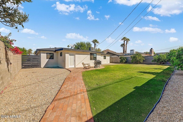 back of property with a patio and a lawn