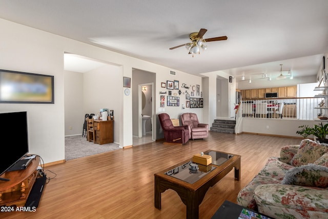 living room featuring light wood-type flooring and ceiling fan