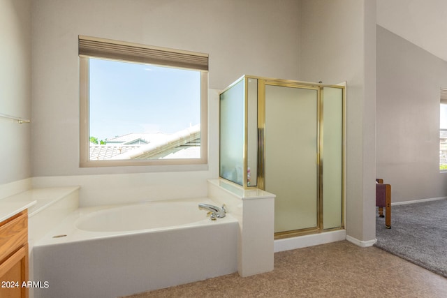 bathroom featuring vanity, plus walk in shower, and plenty of natural light