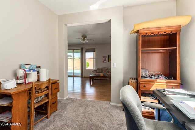 carpeted office with ceiling fan