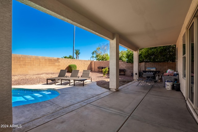 view of patio / terrace with a fenced in pool