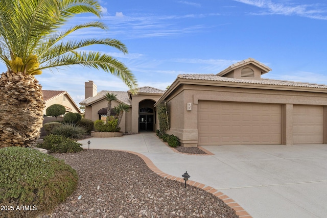 mediterranean / spanish-style home with a garage