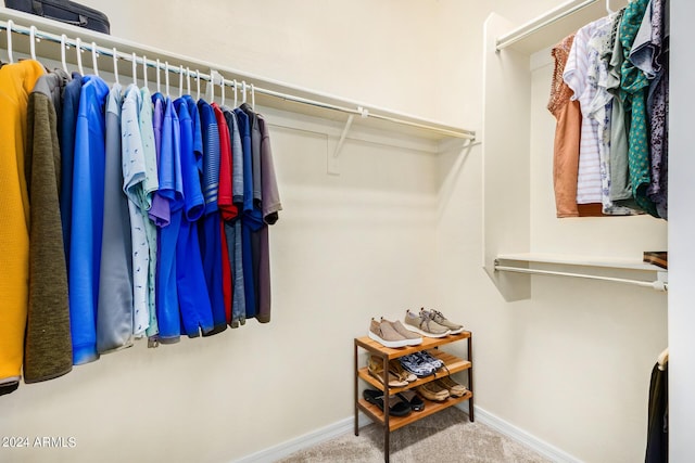 walk in closet featuring carpet