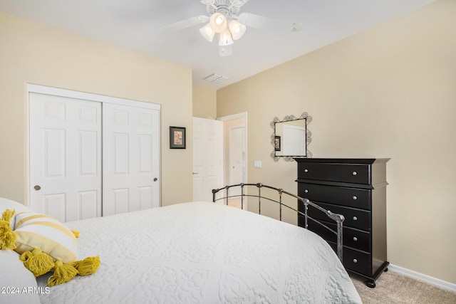 carpeted bedroom featuring ceiling fan and a closet