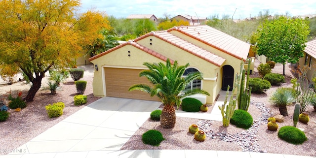 mediterranean / spanish-style house with a garage