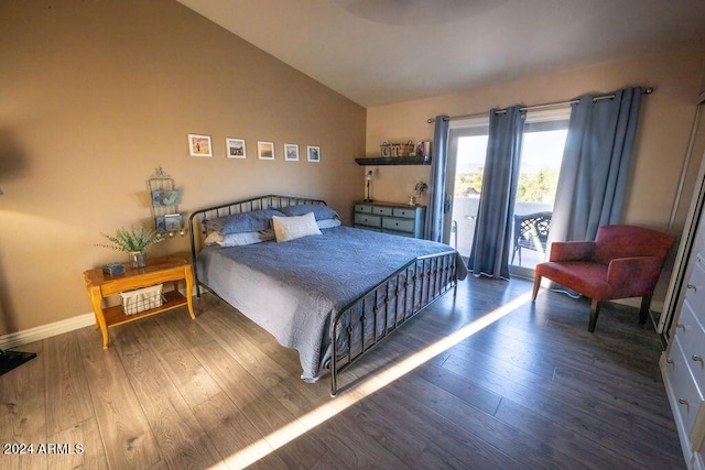 bedroom with access to outside, lofted ceiling, and dark hardwood / wood-style floors