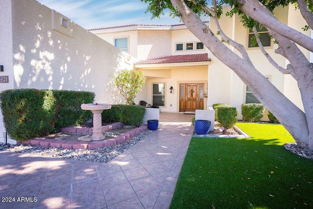 rear view of house featuring a lawn