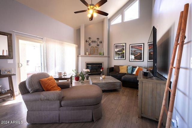 living room with dark hardwood / wood-style flooring, high vaulted ceiling, and ceiling fan