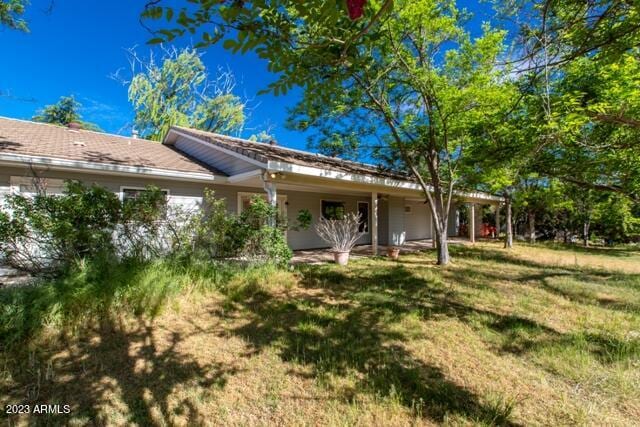 rear view of house with a yard