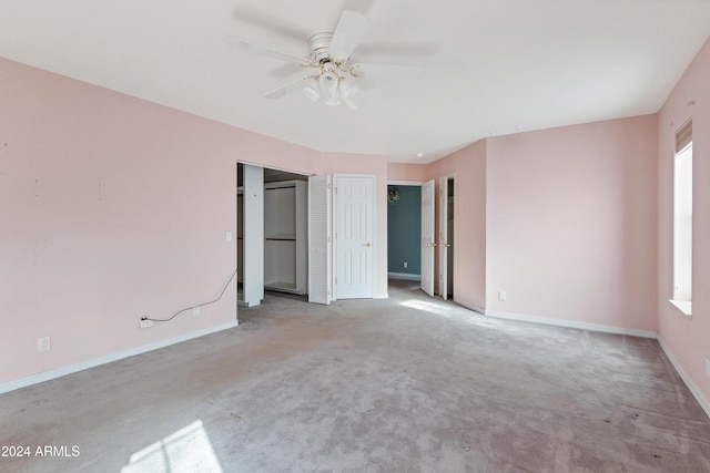 unfurnished bedroom featuring ceiling fan and light colored carpet