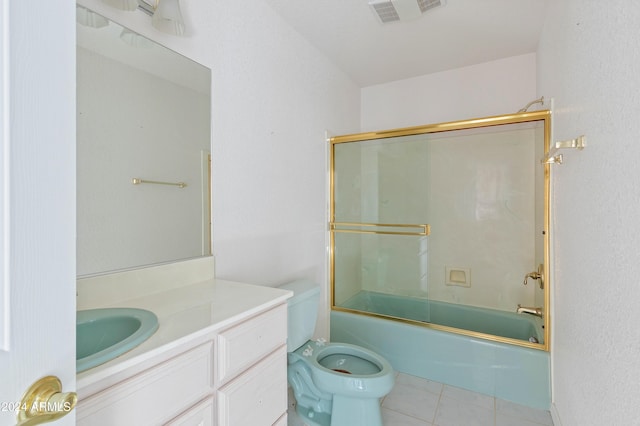 full bathroom with tile patterned floors, vanity, toilet, and combined bath / shower with glass door