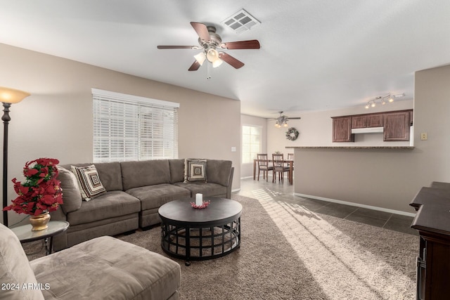 tiled living room with ceiling fan