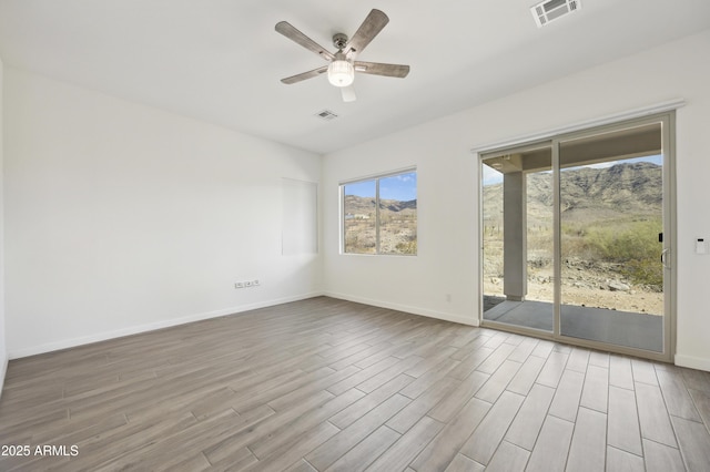 10540 S 32nd Dr, Laveen, AZ 85339 - spare room with a ceiling fan, wood finished floors, and baseboards