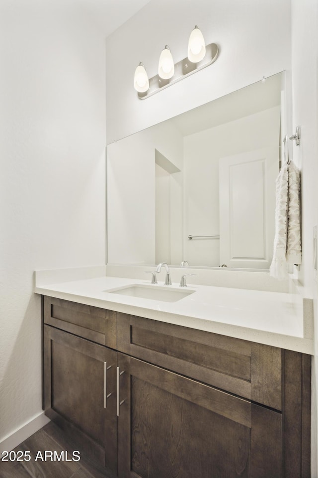 10540 S 32nd Dr, Laveen, AZ 85339 - bathroom featuring vanity, baseboards, and wood finished floors