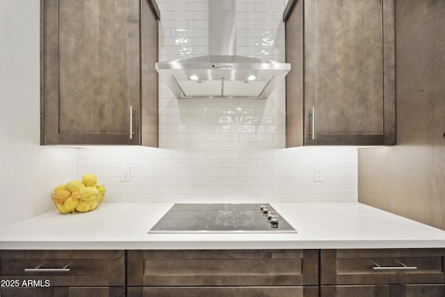 10540 S 32nd Dr, Laveen, AZ 85339 - kitchen featuring black electric stovetop, wall chimney exhaust hood, dark brown cabinets, and decorative backsplash