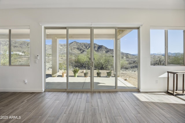 10540 S 32nd Dr, Laveen, AZ 85339 - doorway with a mountain view, wood finished floors, and baseboards