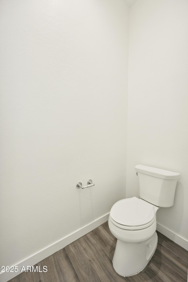 10540 S 32nd Dr, Laveen, AZ 85339 - bathroom with baseboards, wood finished floors, and toilet