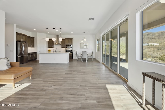 10540 S 32nd Dr, Laveen, AZ 85339 - living area featuring recessed lighting, light wood-style floors, and a mountain view
