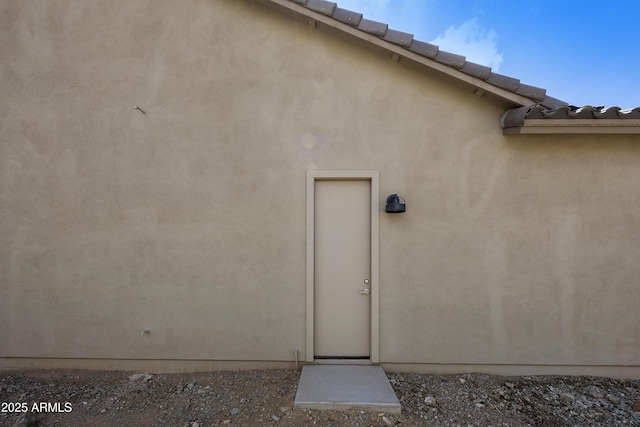 10540 S 32nd Dr, Laveen, AZ 85339 - doorway to property featuring a tile roof and stucco siding