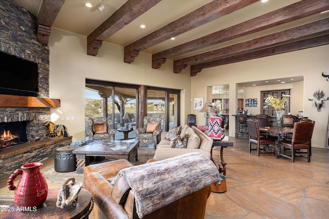 living room featuring a fireplace, beam ceiling, and recessed lighting